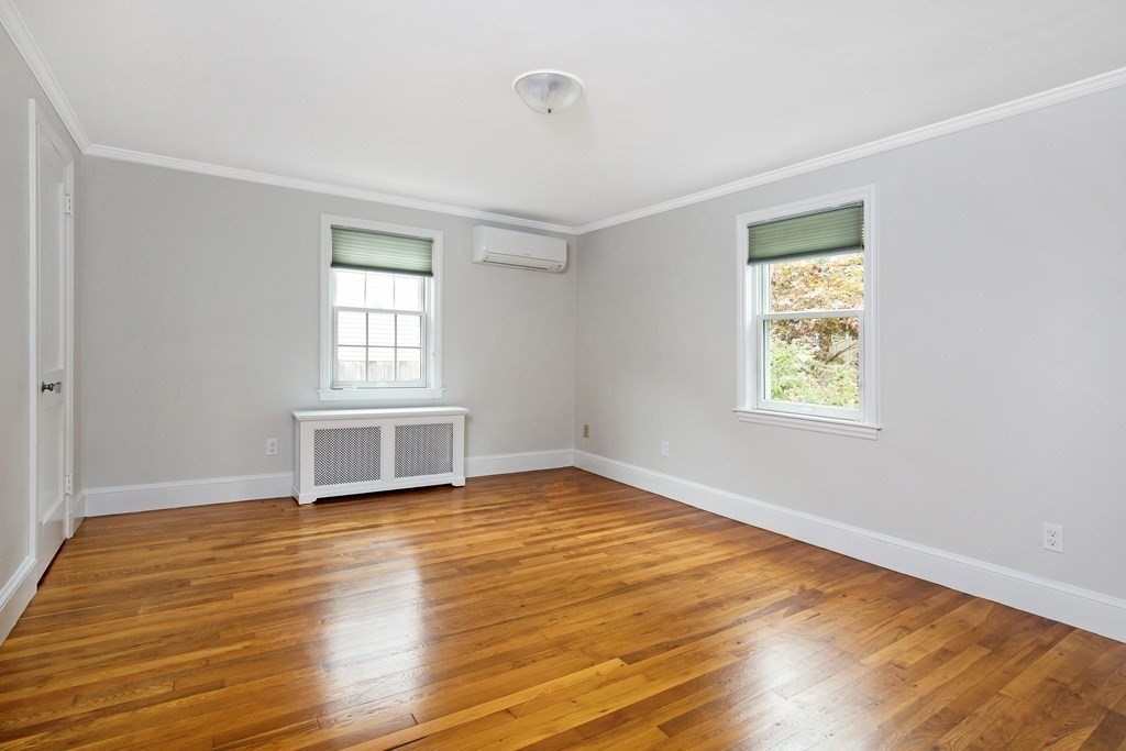 496 Marrett Road Lexington, MA 02421 - Photo 11 of 25 a view of an empty room with wooden floor and a window