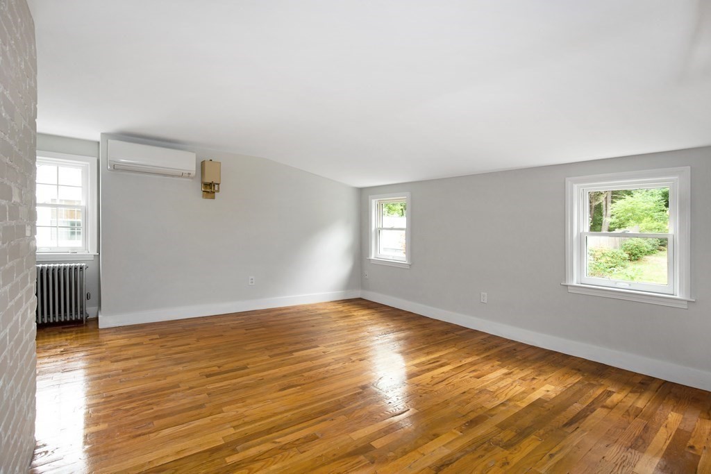 496 Marrett Road Lexington, MA 02421 - Photo 13 of 25 a view of an empty room with window and wooden floor