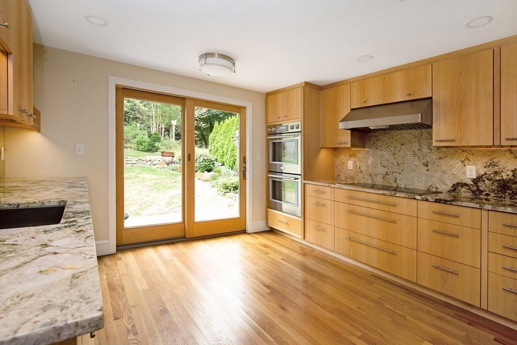 496 Marrett Road Lexington, MA 02421 - Photo 6 of 25 a kitchen with granite countertop wooden cabinets and a stove