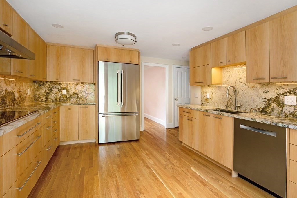 496 Marrett Road Lexington, MA 02421 - Photo 7 of 25 a kitchen with stainless steel appliances a refrigerator and a stove top oven