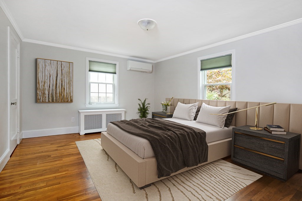 496 Marrett Road Lexington, MA 02421 - Photo 10 of 25 a bedroom with a bed and wooden floor