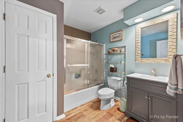 a bathroom with a toilet sink and shower