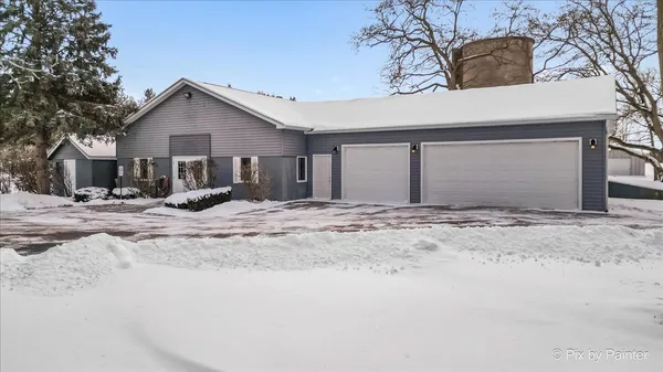 a view of a house with snow on the road