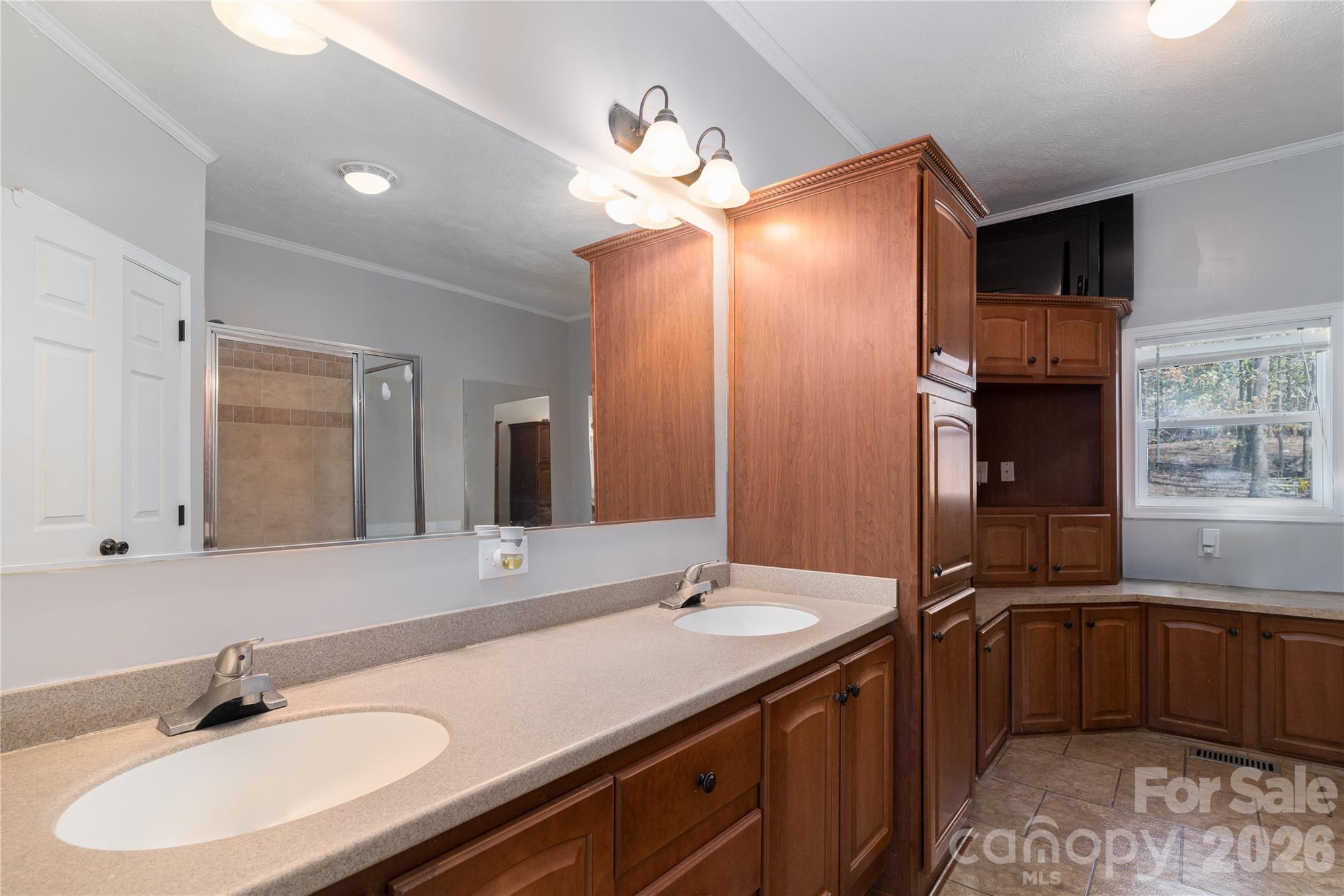 296 Stillwater Road Troutman, NC 28166 - Photo 26 of 33 a bathroom with a double vanity sink and a mirror
