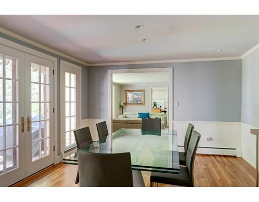 47 Draper Road Wayland, MA 01778 - Photo 6 of 26 a view of dining room and livingroom with furniture wooden floor a rug and a chandelier