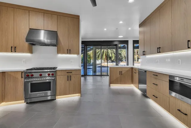 a view of a kitchen with cabinets and a stove top oven