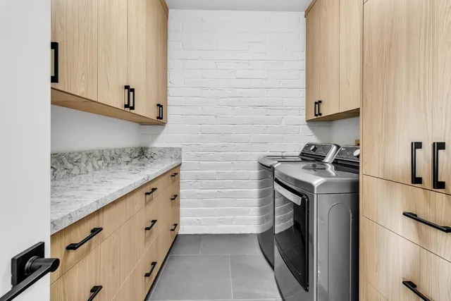 a spacious bedroom with a bed and a cabinets