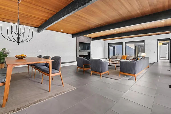 a view of an empty room with wooden floor and a balcony