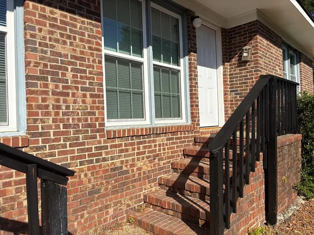 a view of front door of house with stairs
