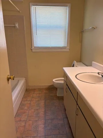 a bathroom with a sink a toilet and bathtub