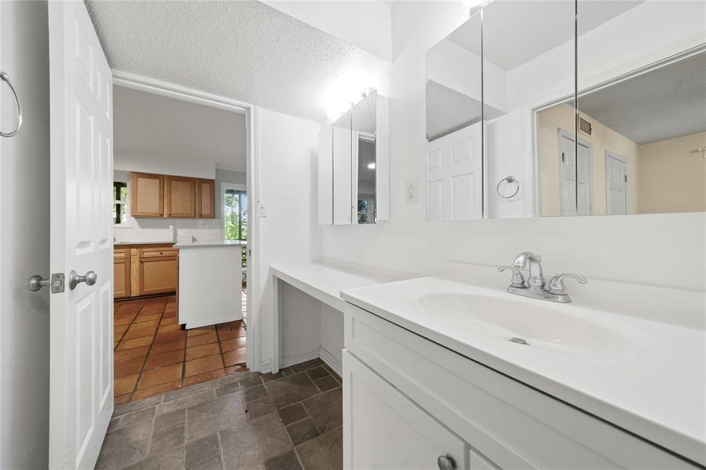 216 Pinewood Lane Hideaway, TX 75771 - Photo 18 of 40 a bathroom with a sink and a mirror
