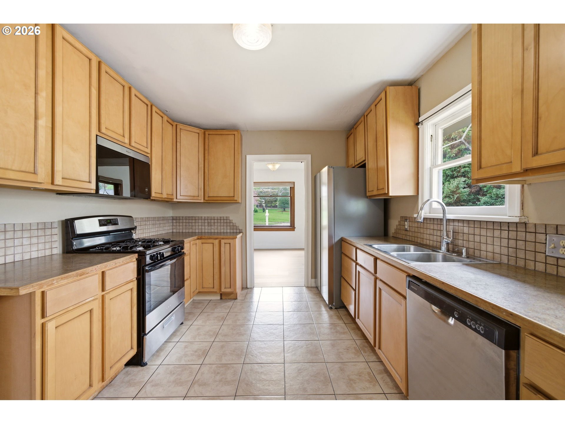 1804 Division Street Camas, WA 98607 - Photo 16 of 43 a kitchen with stainless steel appliances granite countertop a sink stove and refrigerator