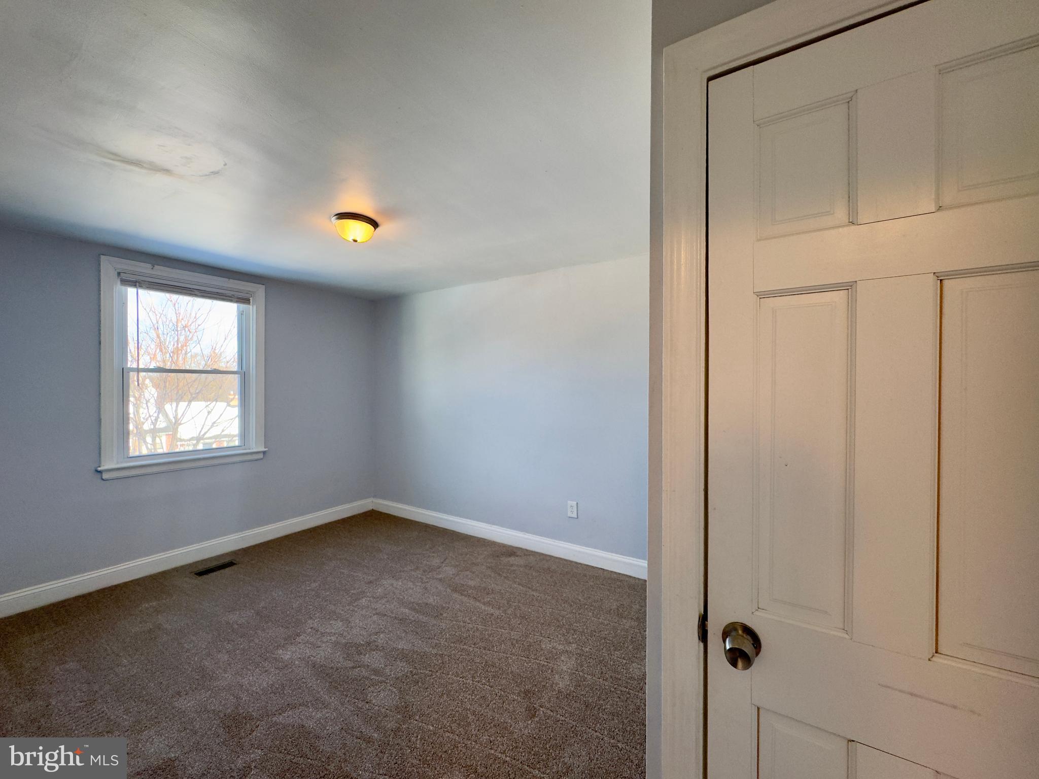 902 Andover Road Baltimore, MD 21218 - Photo 12 of 22 an empty room with windows and closet