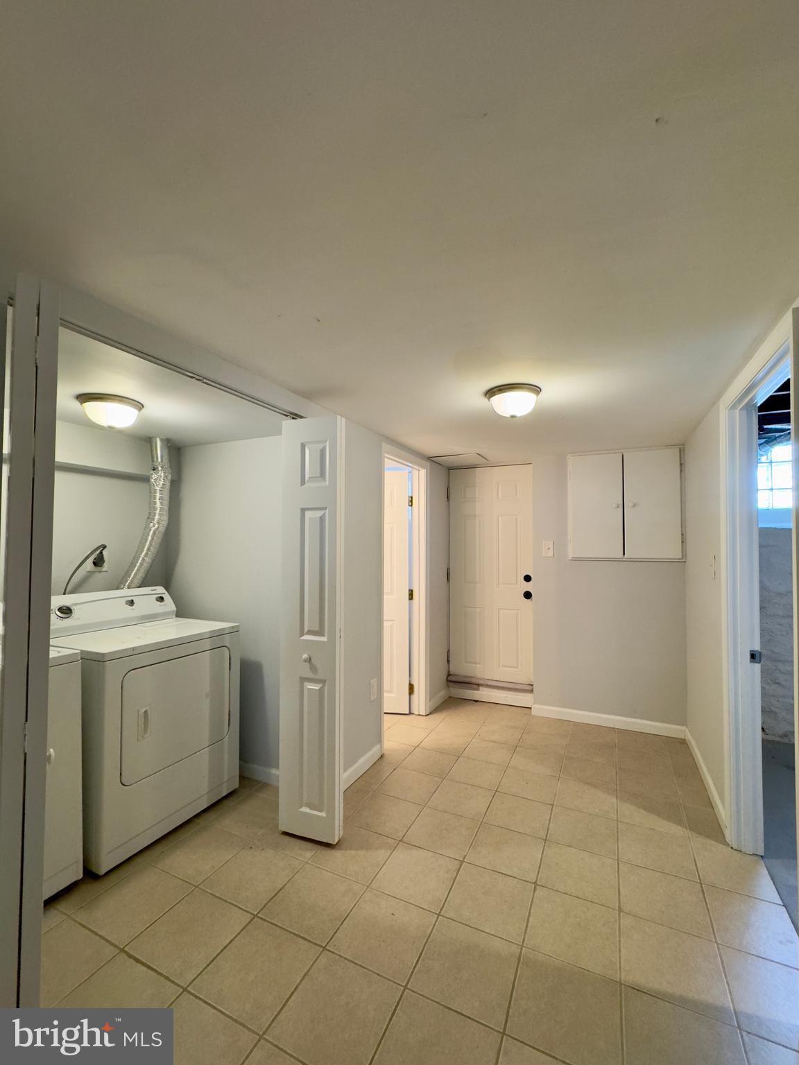 902 Andover Road Baltimore, MD 21218 - Photo 15 of 22 a view of a kitchen with white cabinets and utility room