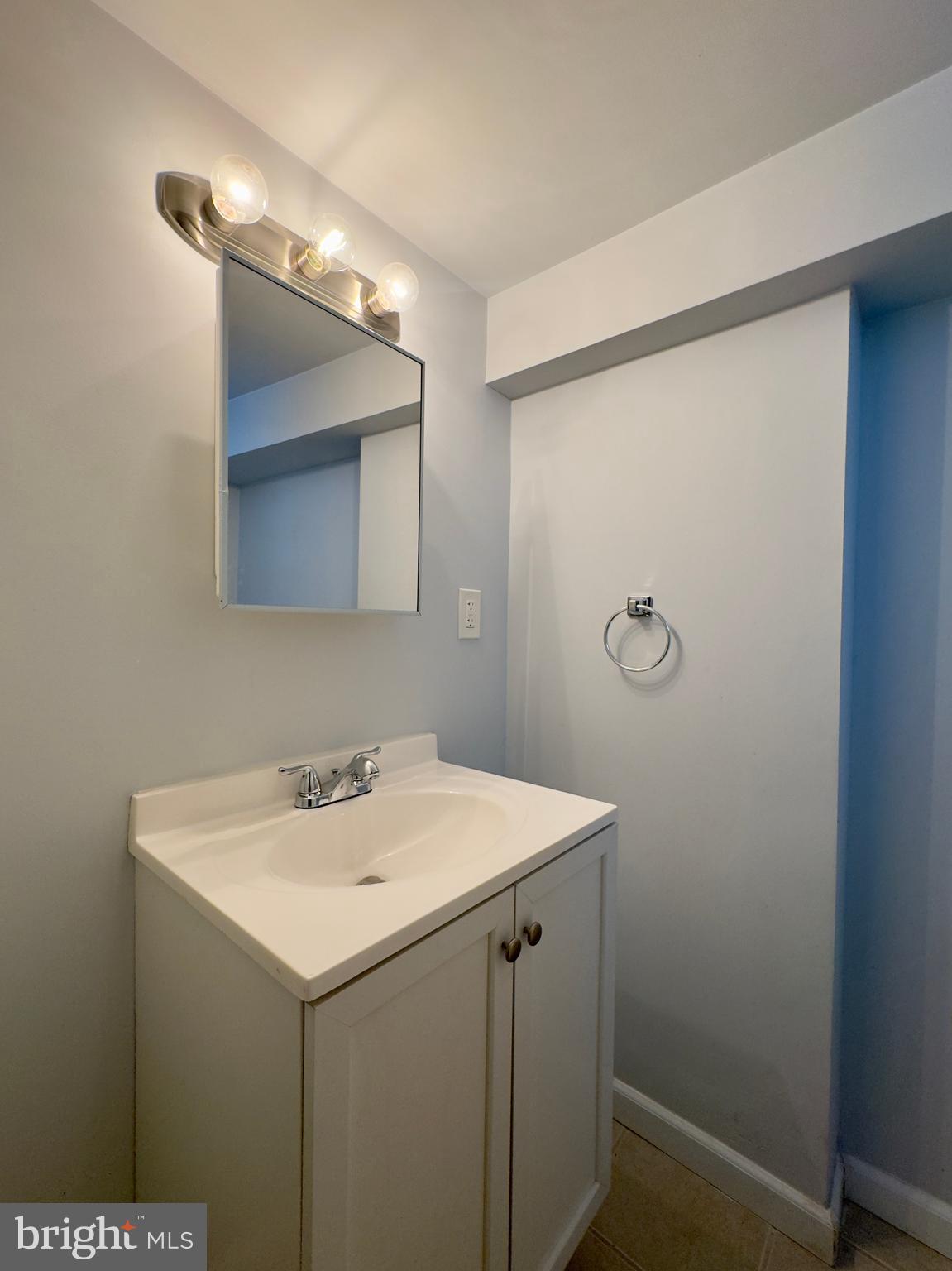 902 Andover Road Baltimore, MD 21218 - Photo 18 of 22 a bathroom with a sink and mirror