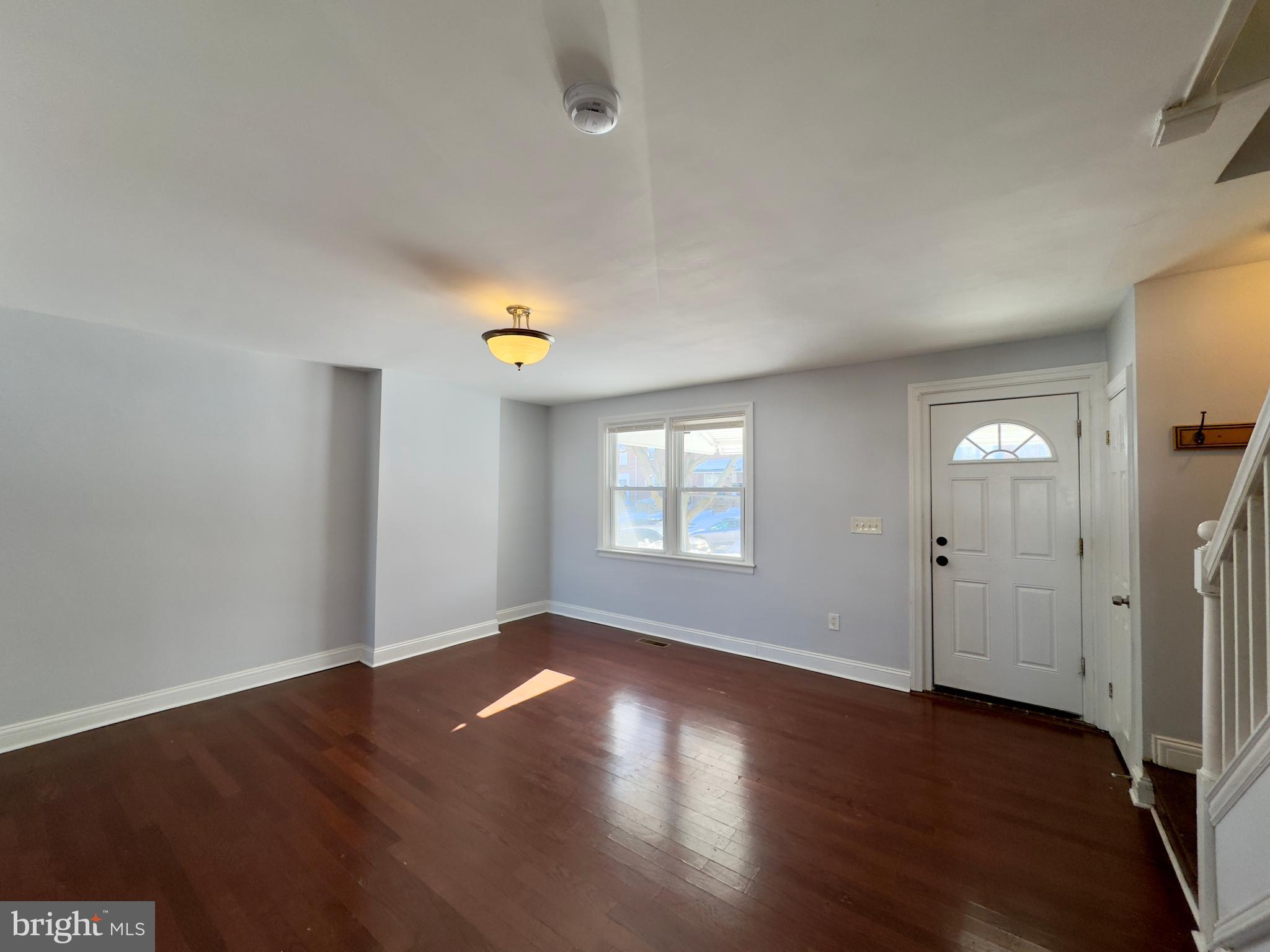902 Andover Road Baltimore, MD 21218 - Photo 20 of 22 an empty room with wooden floor and windows