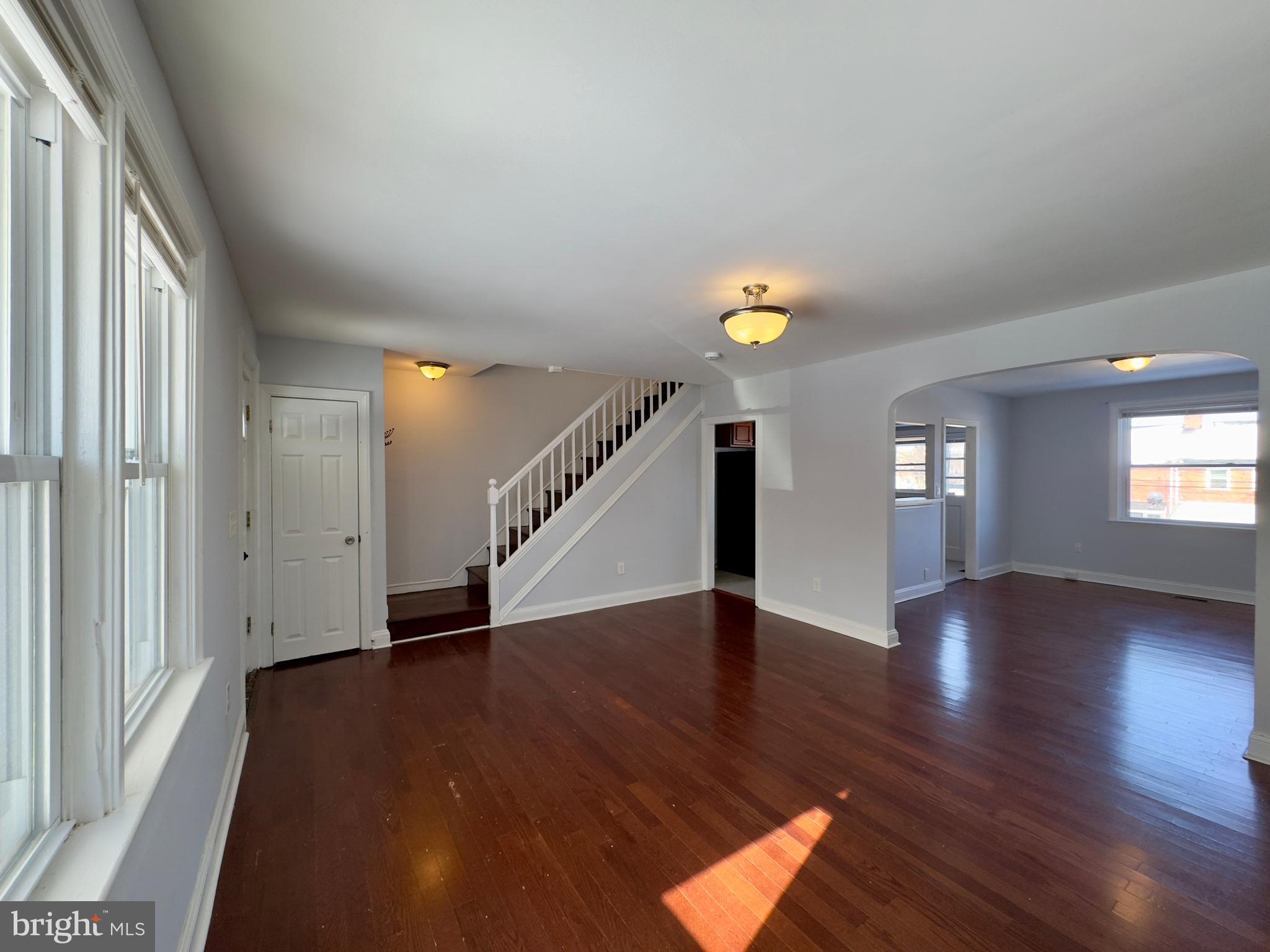 902 Andover Road Baltimore, MD 21218 - Photo 21 of 22 an empty room with wooden floor and windows