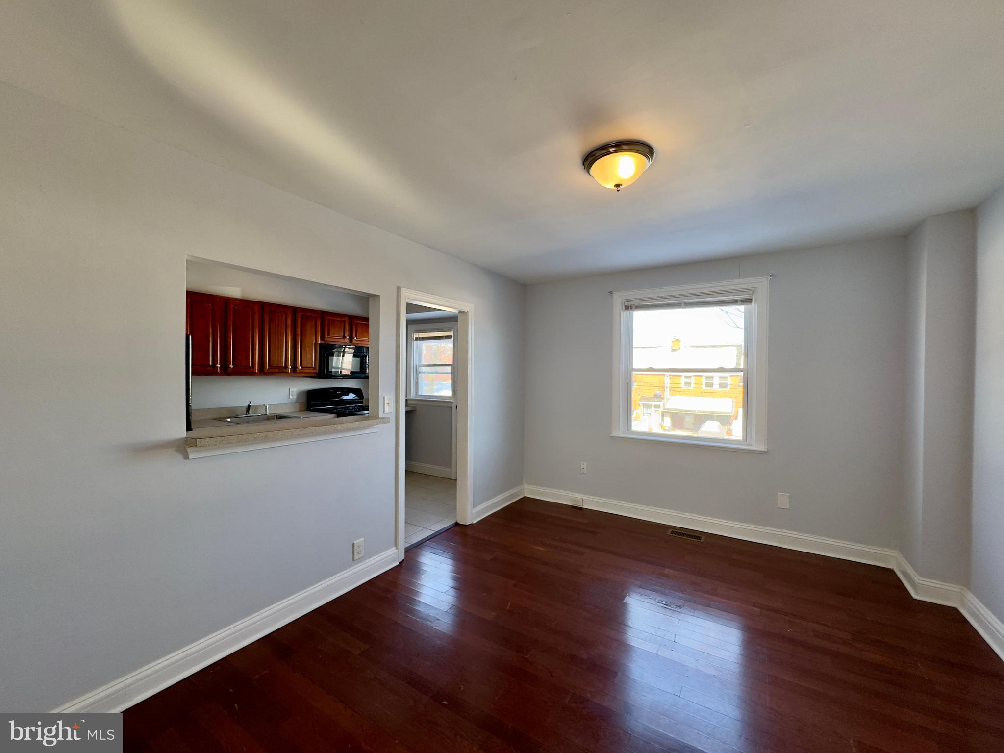 902 Andover Road Baltimore, MD 21218 - Photo 3 of 22 a view of a hallway with wooden floor and a living room