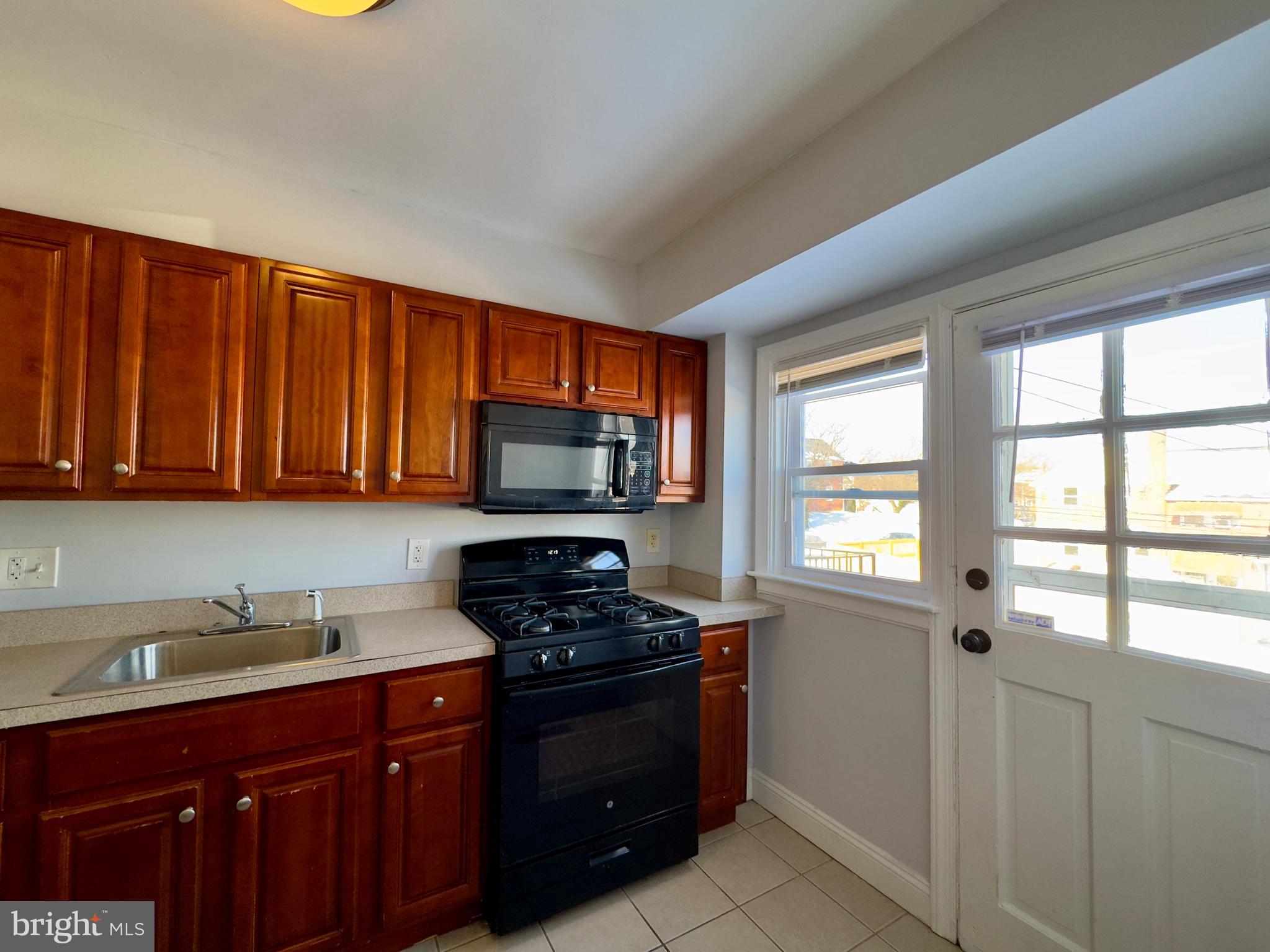 902 Andover Road Baltimore, MD 21218 - Photo 5 of 22 a kitchen with stainless steel appliances a stove a sink and a microwave