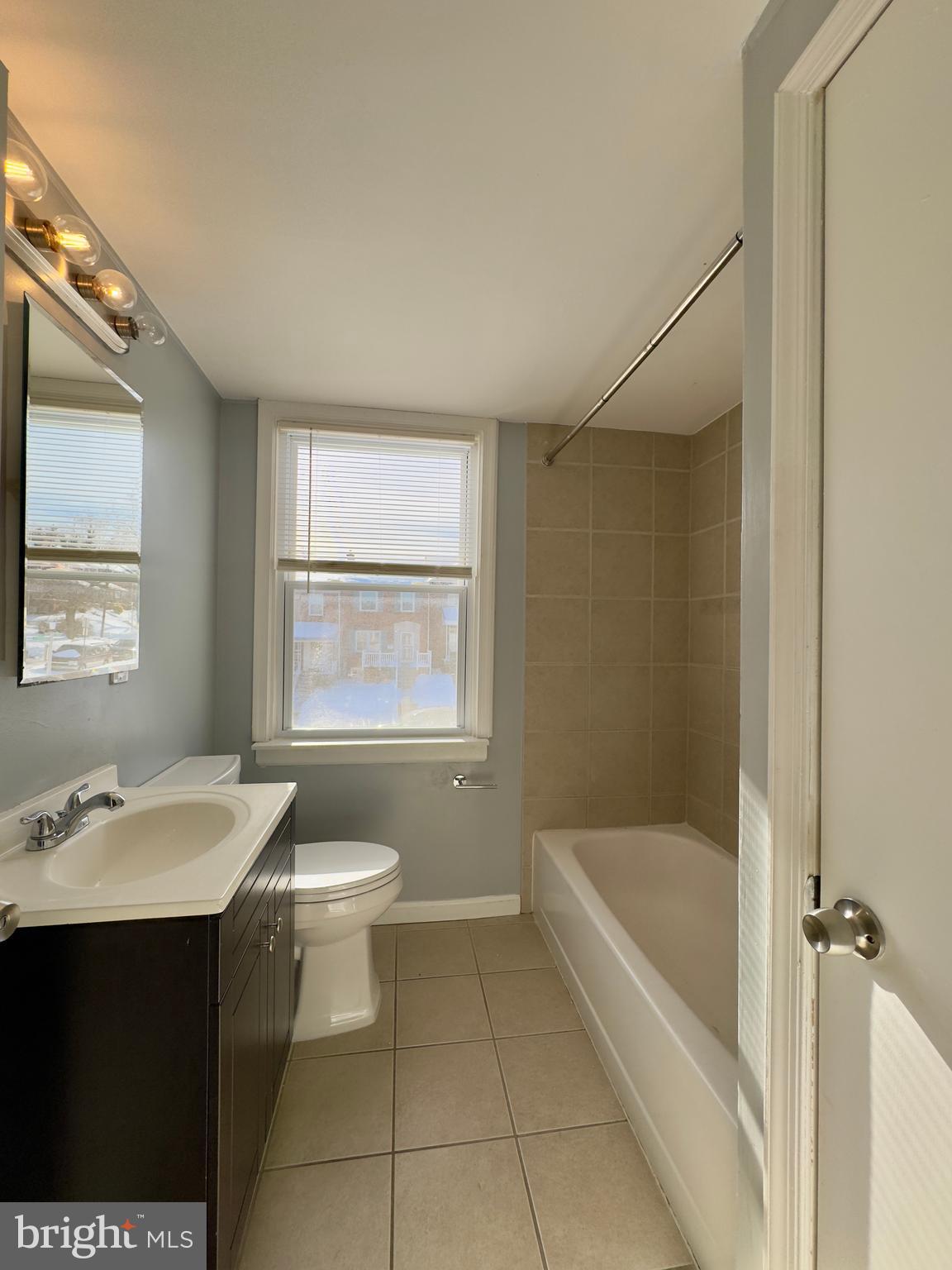 902 Andover Road Baltimore, MD 21218 - Photo 9 of 22 a bathroom with a sink a toilet and shower