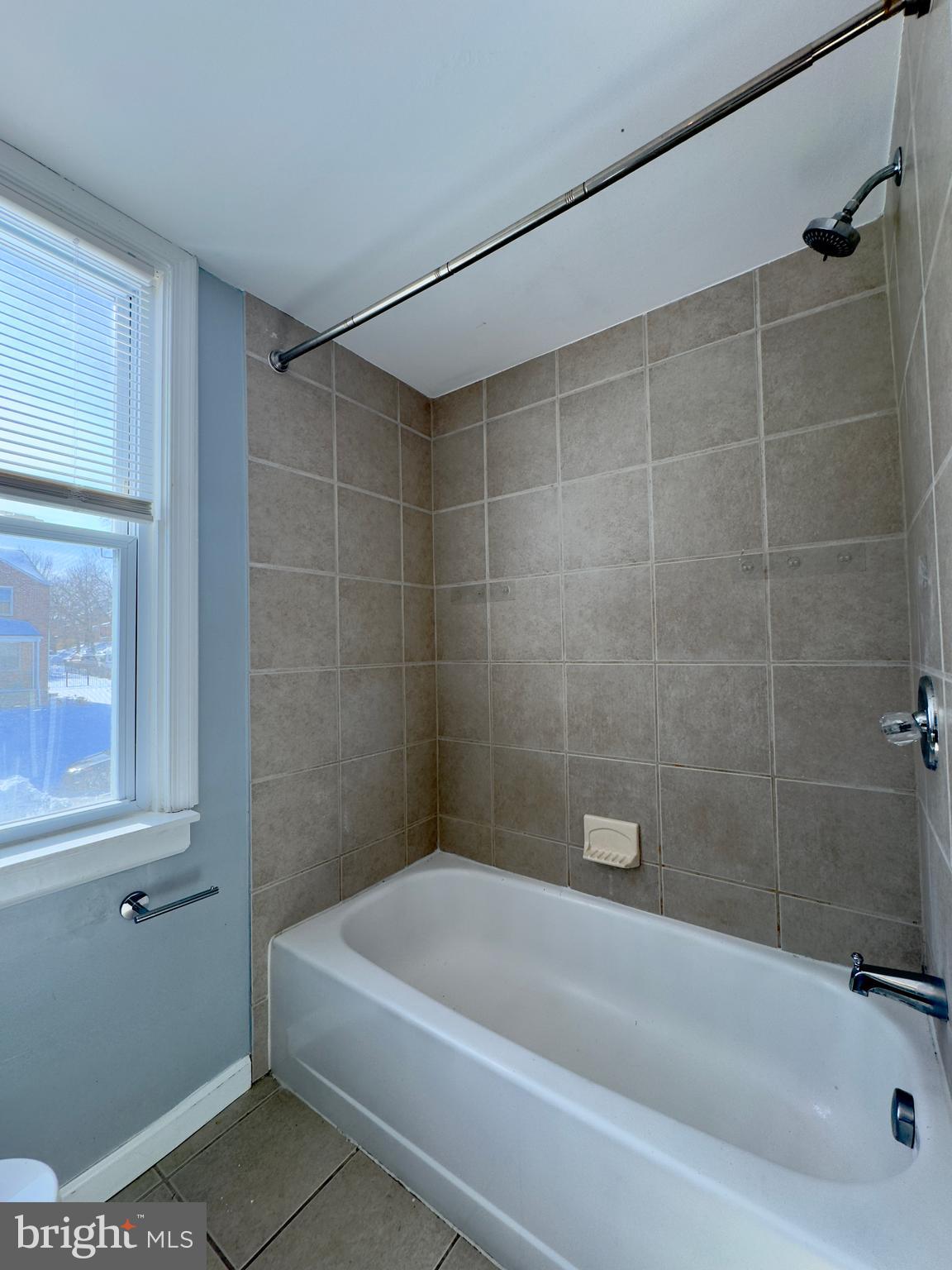 902 Andover Road Baltimore, MD 21218 - Photo 10 of 22 a bath tub sitting next to a white sink and vanity