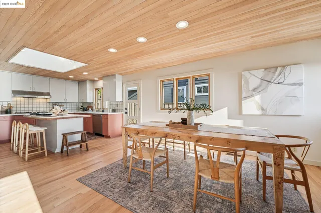 a view of a dining room with furniture and a large window