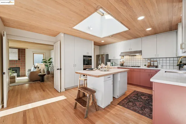 a kitchen with stainless steel appliances a sink counter space cabinets and a counter top space