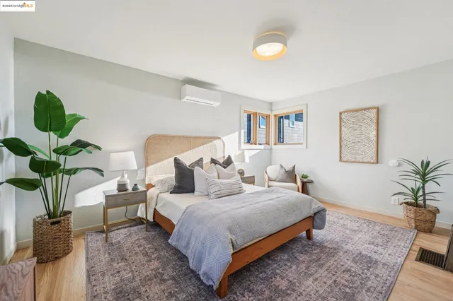 a bedroom with a bed and a mirror