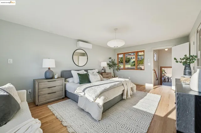 a bedroom with a bed and a view of kitchen