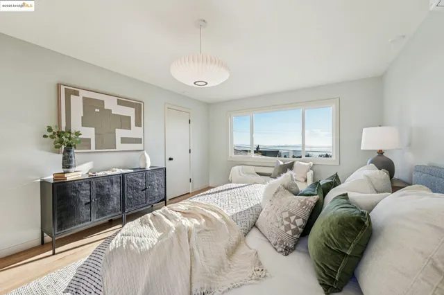 a bathroom with a granite countertop toilet sink and mirror