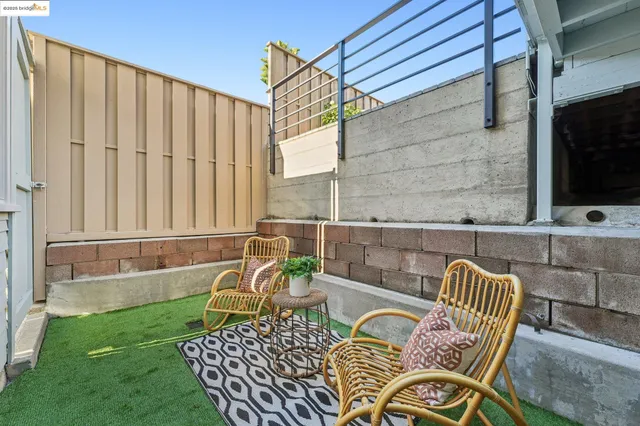 a view of a patio with couches table and chairs and potted plants