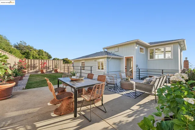 a view of a patio with table and chairs and potted plants