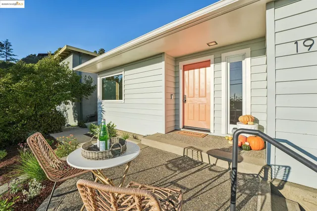 a living room with furniture fireplace and a large window