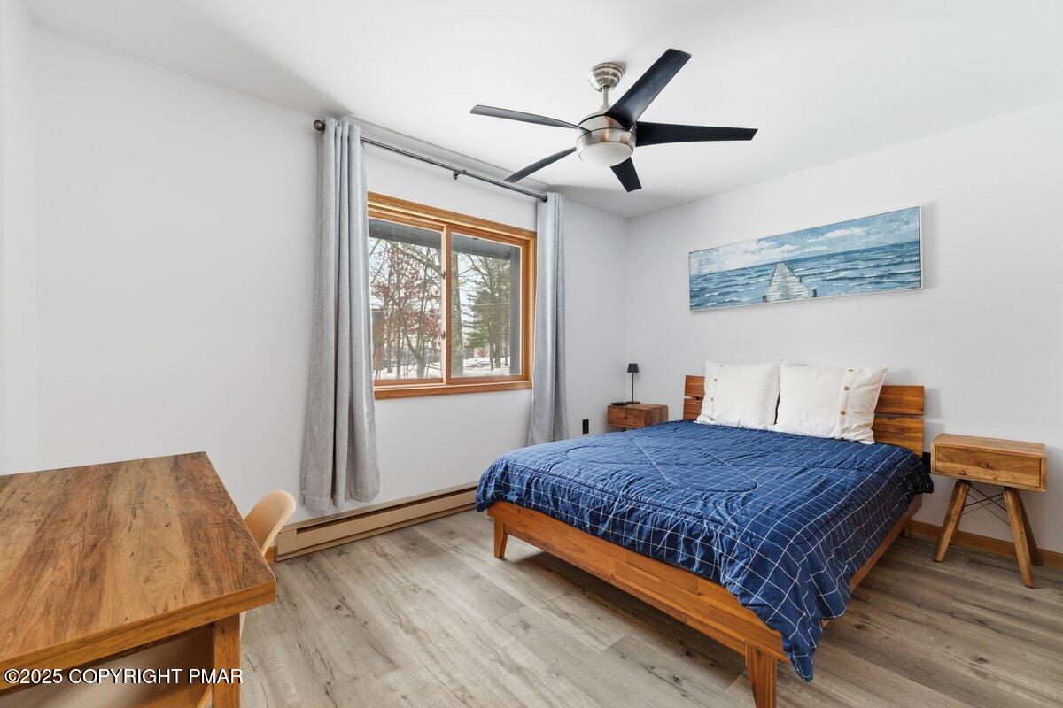 2260 Apley Court Bushkill, PA 18324 - Photo 14 of 44 a bedroom with a bed and wooden floor