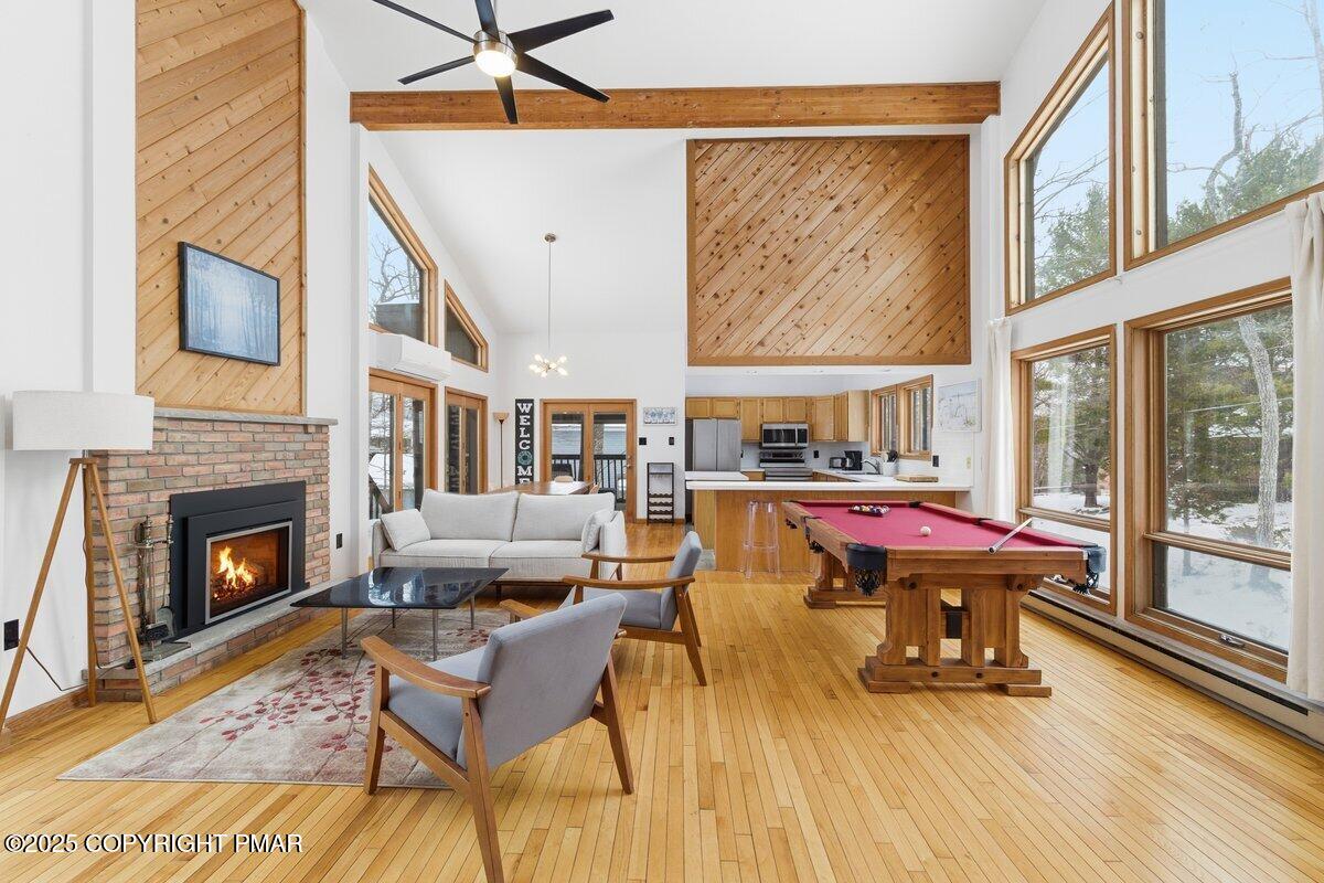 2260 Apley Court Bushkill, PA 18324 - Photo 40 of 44 a living room with a fireplace a rug and a floor to ceiling window