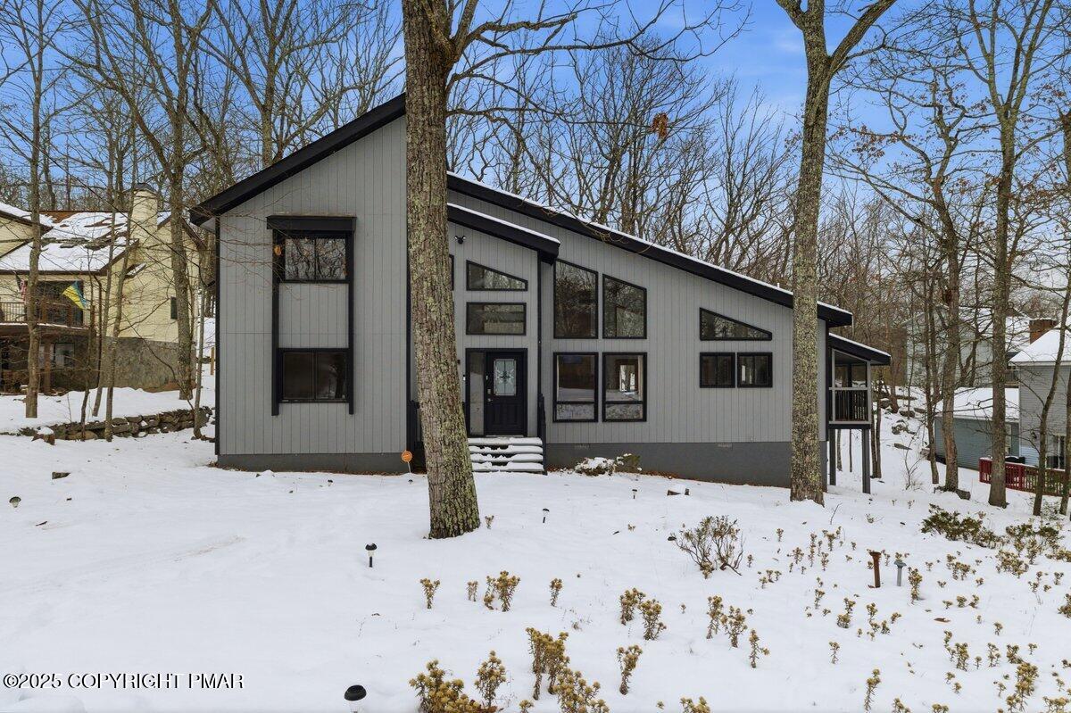 2260 Apley Court Bushkill, PA 18324 - Photo 36 of 44 a front view of a house with a yard covered in snow