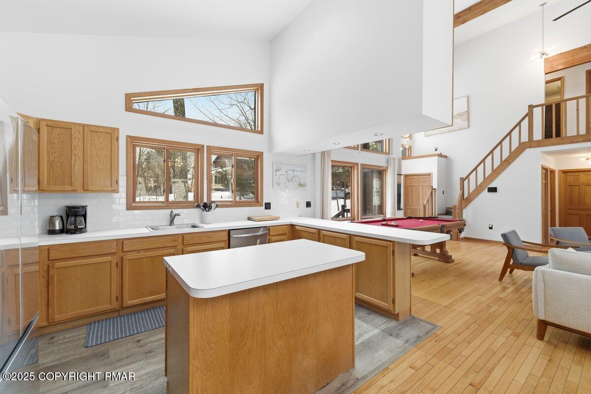 2260 Apley Court Bushkill, PA 18324 - Photo 5 of 44 a kitchen with stainless steel appliances a stove a sink dishwasher and cabinets with wooden floor