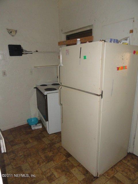 1420 King Arthur Road Jacksonville, FL 32211 - Photo 4 of 7 a white refrigerator freezer sitting in a kitchen