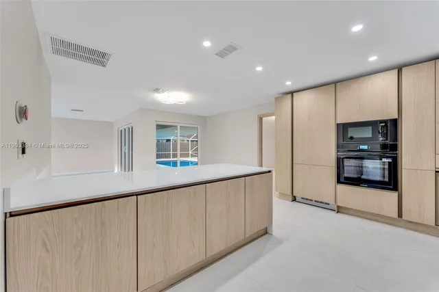 a kitchen with stainless steel appliances a refrigerator and a stove top oven