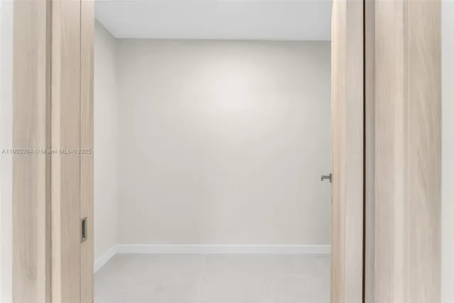 a bedroom with a bed and a potted plant