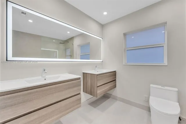 a bathroom with a toilet a sink and shower