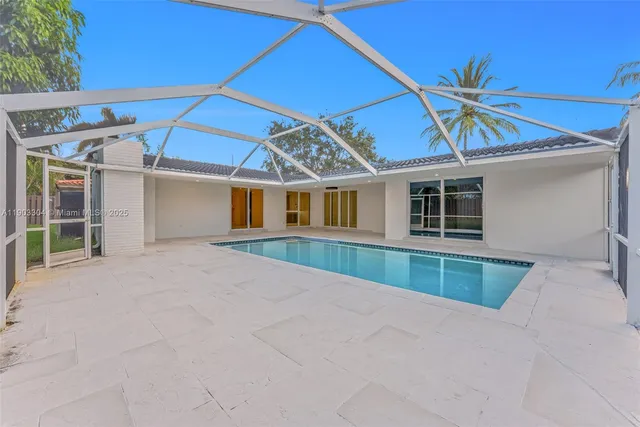 a view of a house with a yard and sitting area