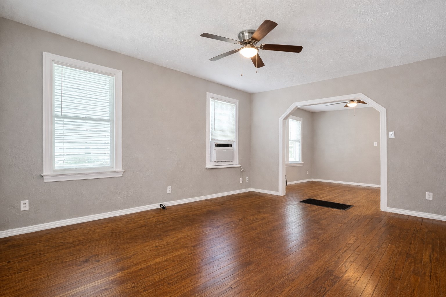 4917 Avenue R 1/2 Galveston, TX 77551 - Photo 2 of 21 Bright living room with hardwood floors and arched opening in a Galveston, Texas home near the Gulf Coast.