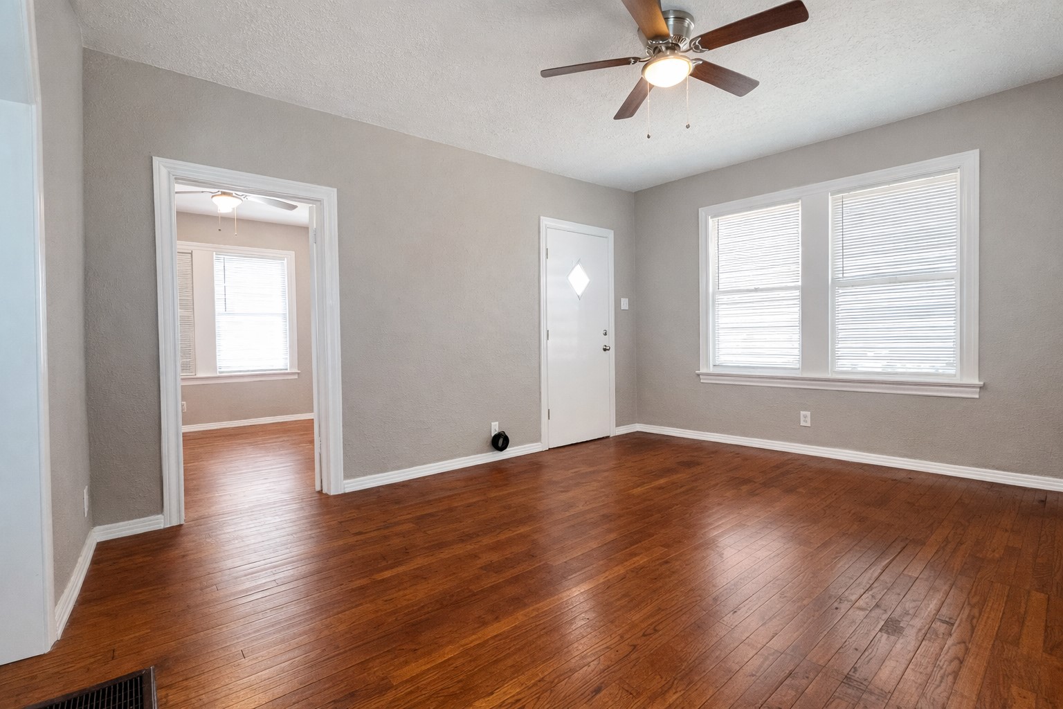 4917 Avenue R 1/2 Galveston, TX 77551 - Photo 10 of 21 Sunlit Galveston TX bedroom with classic hardwood floors and neutral wall tones.