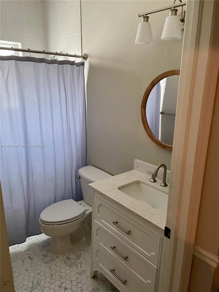 3121 Southeast 2nd Drive Homestead, FL 33033 - Photo 17 of 43 a bathroom with a granite countertop sink toilet and a mirror