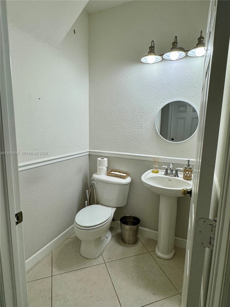 3121 Southeast 2nd Drive Homestead, FL 33033 - Photo 19 of 43 a bathroom with a toilet and a sink