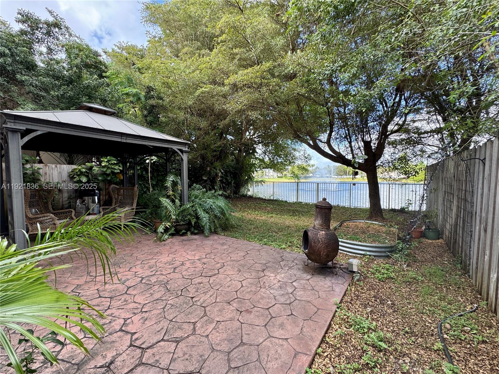 3121 Southeast 2nd Drive Homestead, FL 33033 - Photo 23 of 43 a backyard of a house with fountain table and chairs