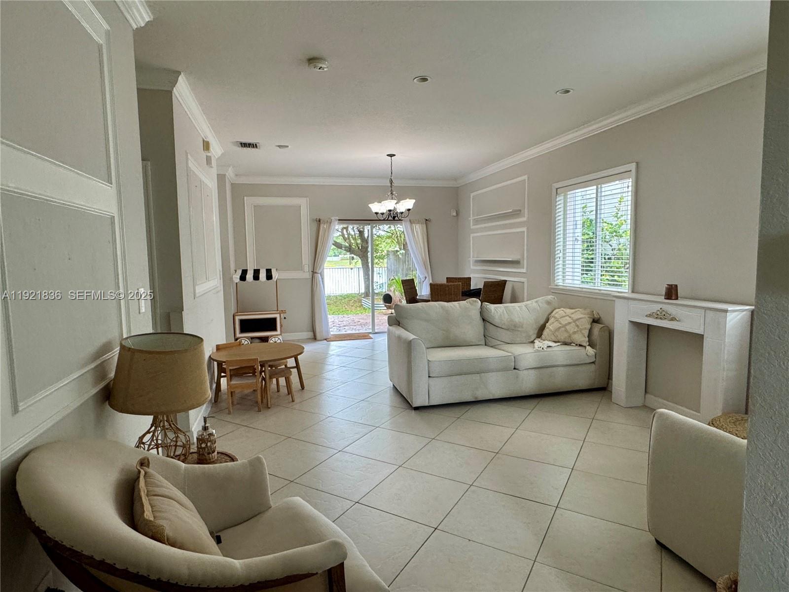 3121 Southeast 2nd Drive Homestead, FL 33033 - Photo 6 of 43 a living room with furniture and a fireplace