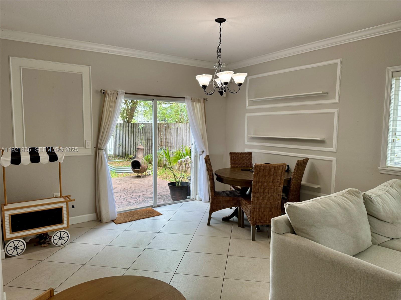 3121 Southeast 2nd Drive Homestead, FL 33033 - Photo 7 of 43 a view of a livingroom with furniture and chandelier