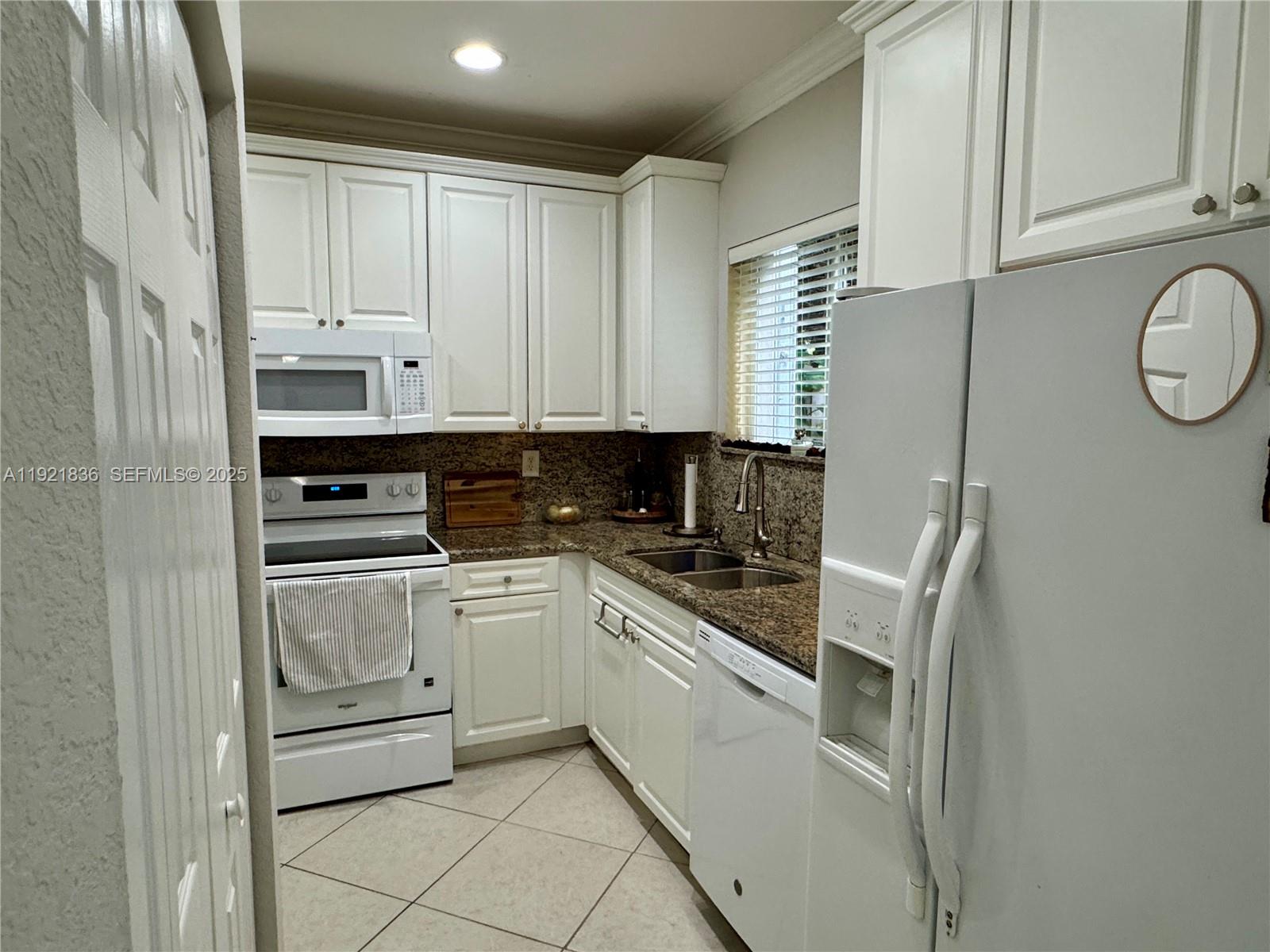 3121 Southeast 2nd Drive Homestead, FL 33033 - Photo 9 of 43 a kitchen with white cabinets and white appliances